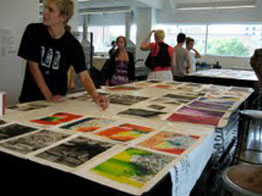many prints and laid out in the studio with printers examining them