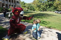 Hooter, Temple's mascot, with two kids