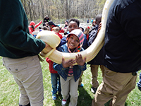 Boy holding a snake at EarthFest 2015