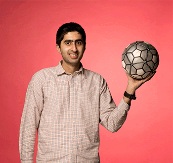 An animated photo of a male student spinning a soccer ball that turns into a globe.