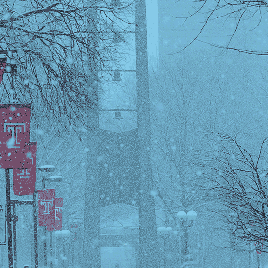 Bell Tower on campus with snow falling.