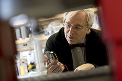 Peter Lelkes looking at a device in the lab.