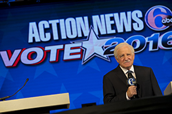 A screen displaying Action News 6abc Vote 2016 and a male debate moderator. 