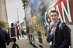 A male student being interviewed in front of the C-SPAN bus. 