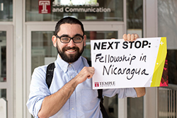 Eli LaBan holding up a sign that says 'Fellowship in Nicaragua.'
