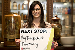 Megan Rubino holding a sign that says “Independent pharmacy”.