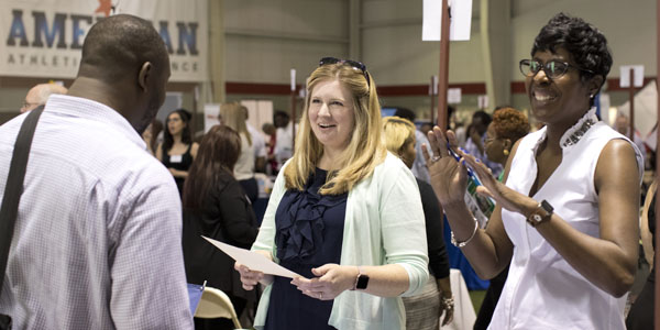 Two people talking at the job fair. 