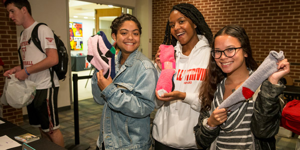 Students donating new socks at the Student Center