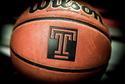 A basketball with a Temple ‘T’ logo on it.