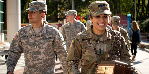 ROTC students carrying the Ranger Challenge trophy on campus