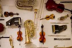 Repaired instruments hang on a wall.