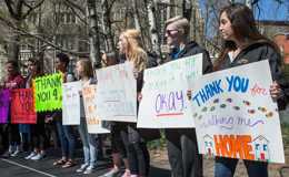 Students holding signs during a walk to raise awareness around sexual assault. 