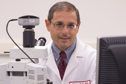 Domenico Praticò, professor of pharmacology, wearing a lab coat.