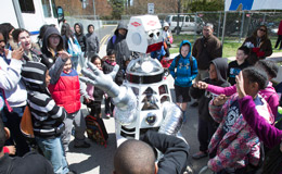 children smiling as they watch a robot at Temple Ambler EarthFest.