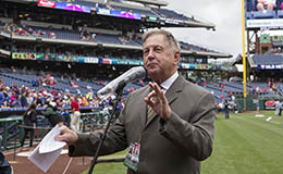 Dan Baker standing on the field at Citizen’s Bank Park speaking into a microphone.
