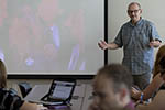 Jim Macmillan talking to students in a classroom.