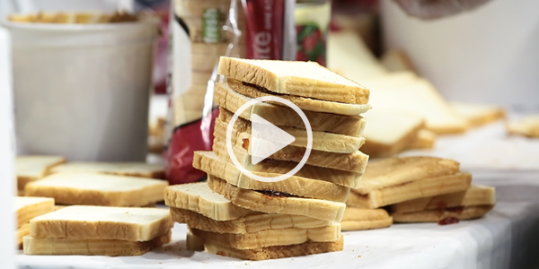 A screenshot of a video of the making of peanut butter and jelly sandwiches.