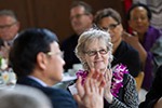A female faculty member applauding during Temple’s Faculty Awards Luncheon.