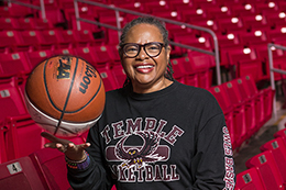 Professor Karen Turner poses with a basketball in the Liacouras Center.
