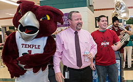 Ken and Kevin Acker celebrating with Hooter at a pop-up pride event.
