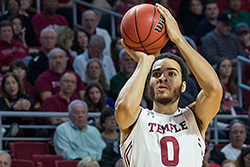 A Temple men’s basketball player shooting a three-point shot.